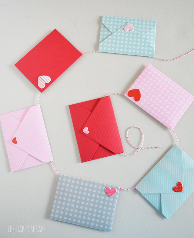 This Mini Envelope Valentine Banner is the perfect addition to your Valentine decor. The mini envelopes are so cute and the puffy heart stickers make the perfect "stamps." Create your own with the tutorial on the blog. 