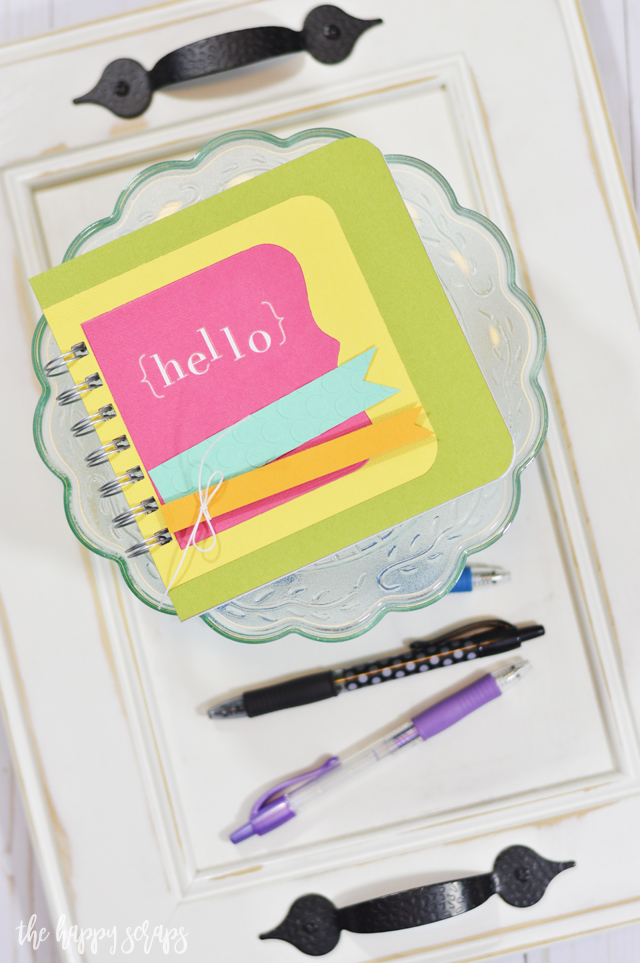 This Hello Mini Notebook is the perfect project for an afternoon craft session. No patterned paper needed, just some good quality cardstock. 