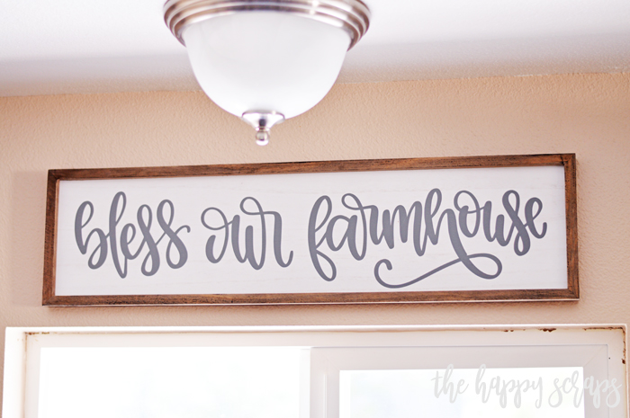 Learn how to use vinyl to create this Bless Our Farmhouse Kitchen Sign. It is a fun project that is perfect for any home. 