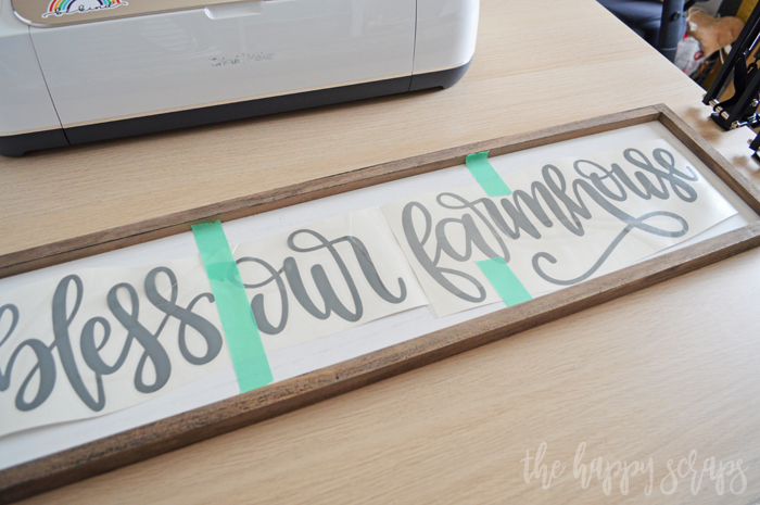 Learn how to use vinyl to create this Bless Our Farmhouse Kitchen Sign. It is a fun project that is perfect for any home. 